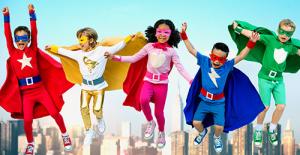 Kids in superhero capes jumping