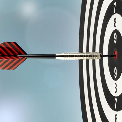 Dartboard with dart hitting a bullseye
