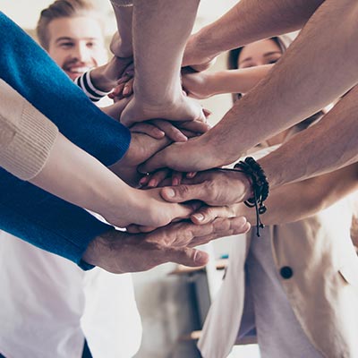 Employees with hands together