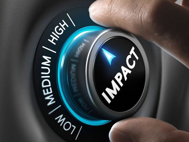 Pushing button with the word Impact on it