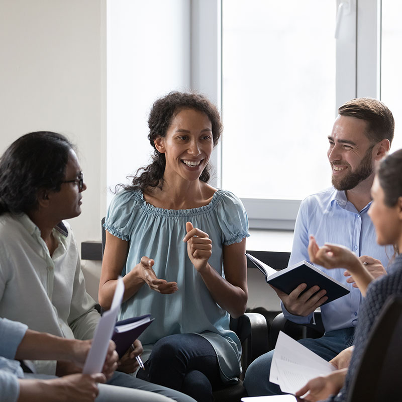 Lady presenting to group of professionals