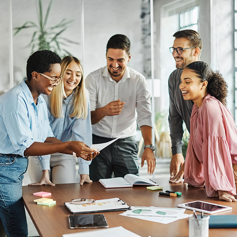 Group of younger professionals in office working