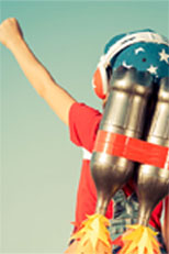 Boy in rocket costume holding arm up