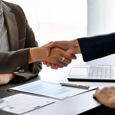 Closeup of HR manager shaking employee's hand