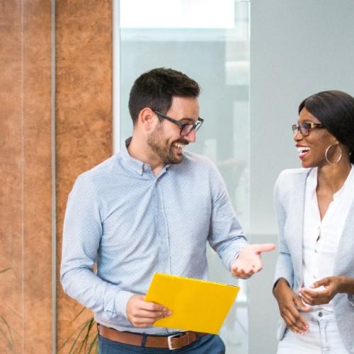 Two colleagues chatting at work