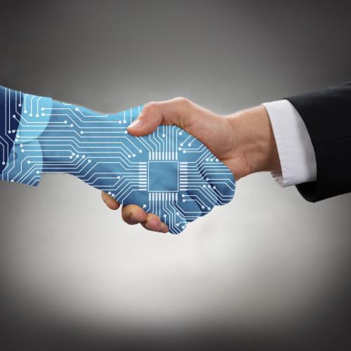 Artificial intelligence hand shaking human hand